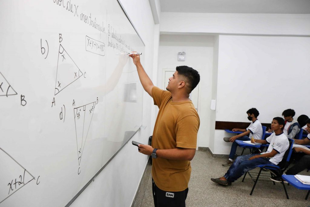 Professora da Seduc-AM conversa com alunos em sala de aula 